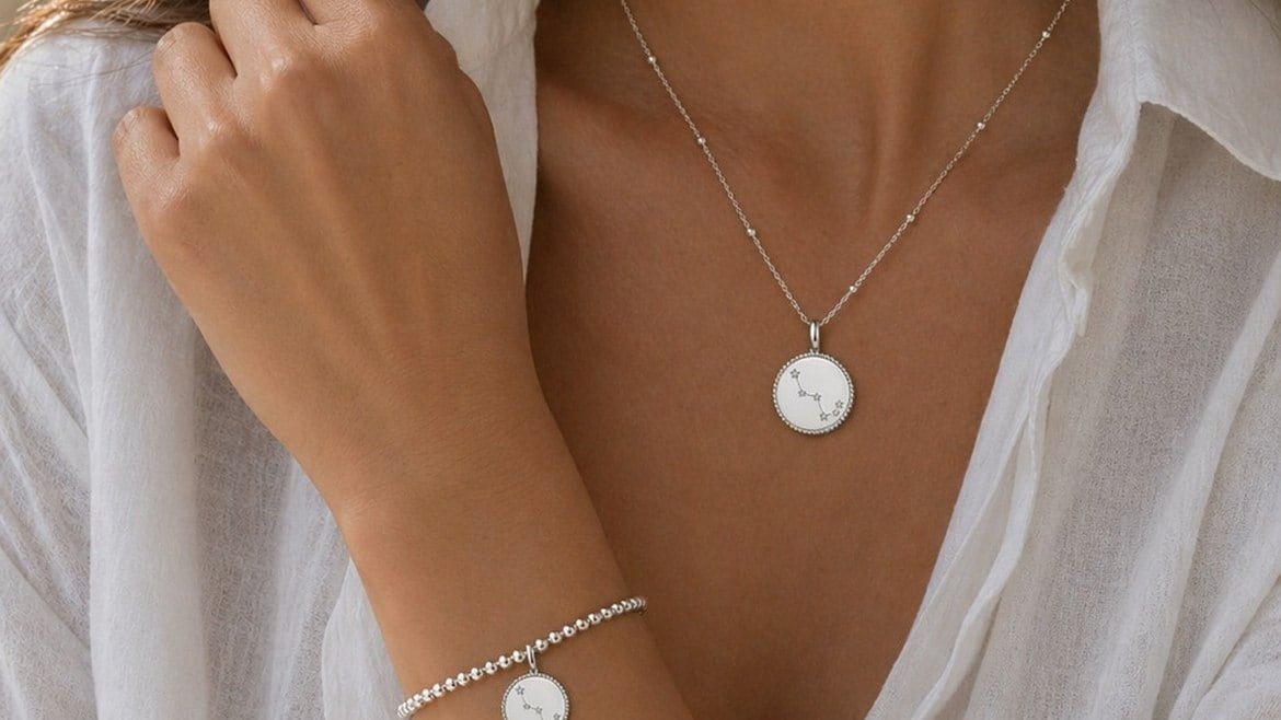 A woman wearing a white shirt and a silver necklace